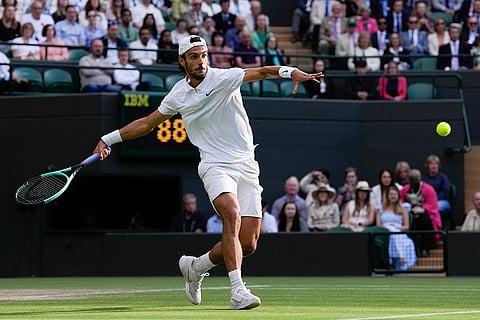 Lorenzo Musetti plays a forehand return to Taylor Fritz